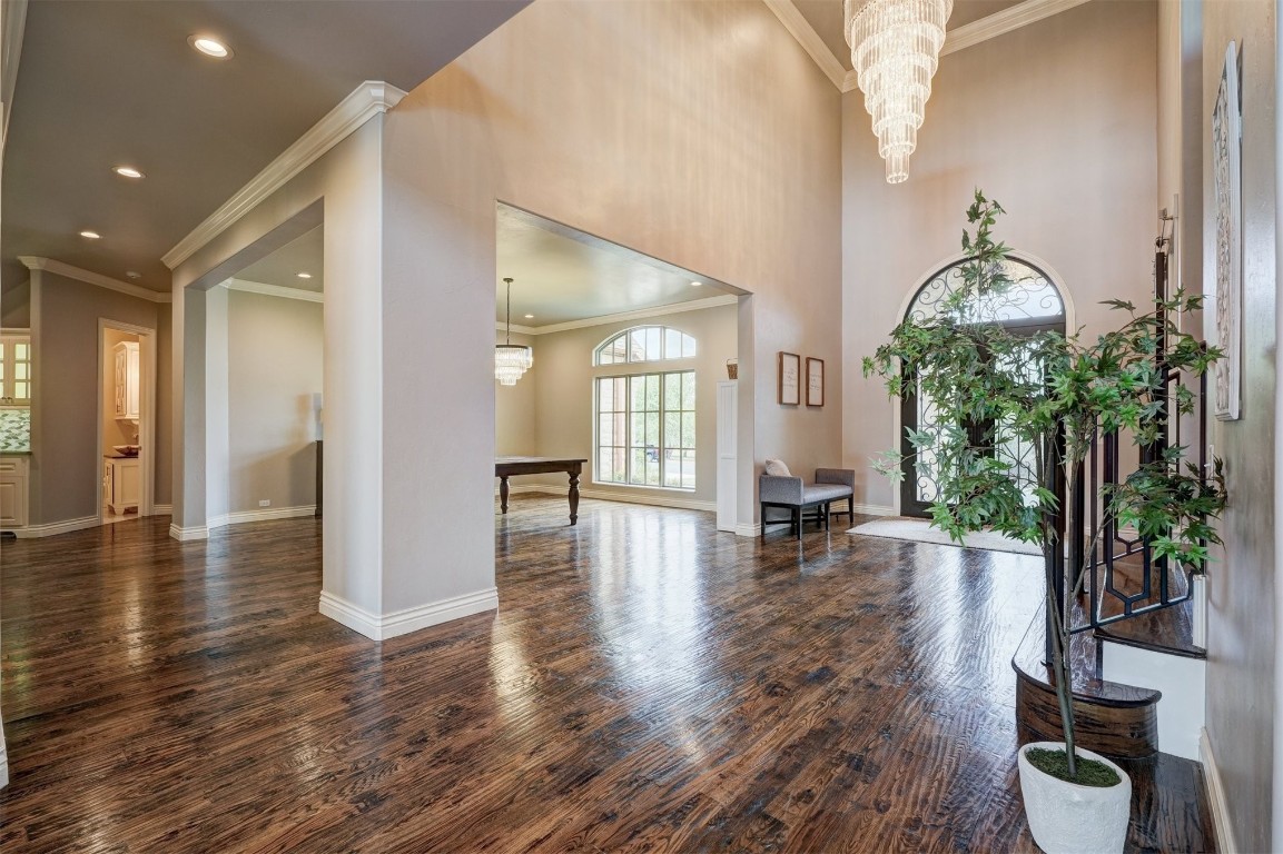 3600 Sea Ray Channel, Edmond, OK 73013 foyer featuring a chandelier, crown molding, and dark hardwood / wood-style floors