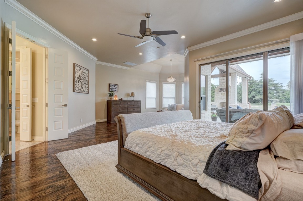 3600 Sea Ray Channel, Edmond, OK 73013 bedroom featuring ornamental molding, ceiling fan, access to exterior, and dark hardwood / wood-style floors