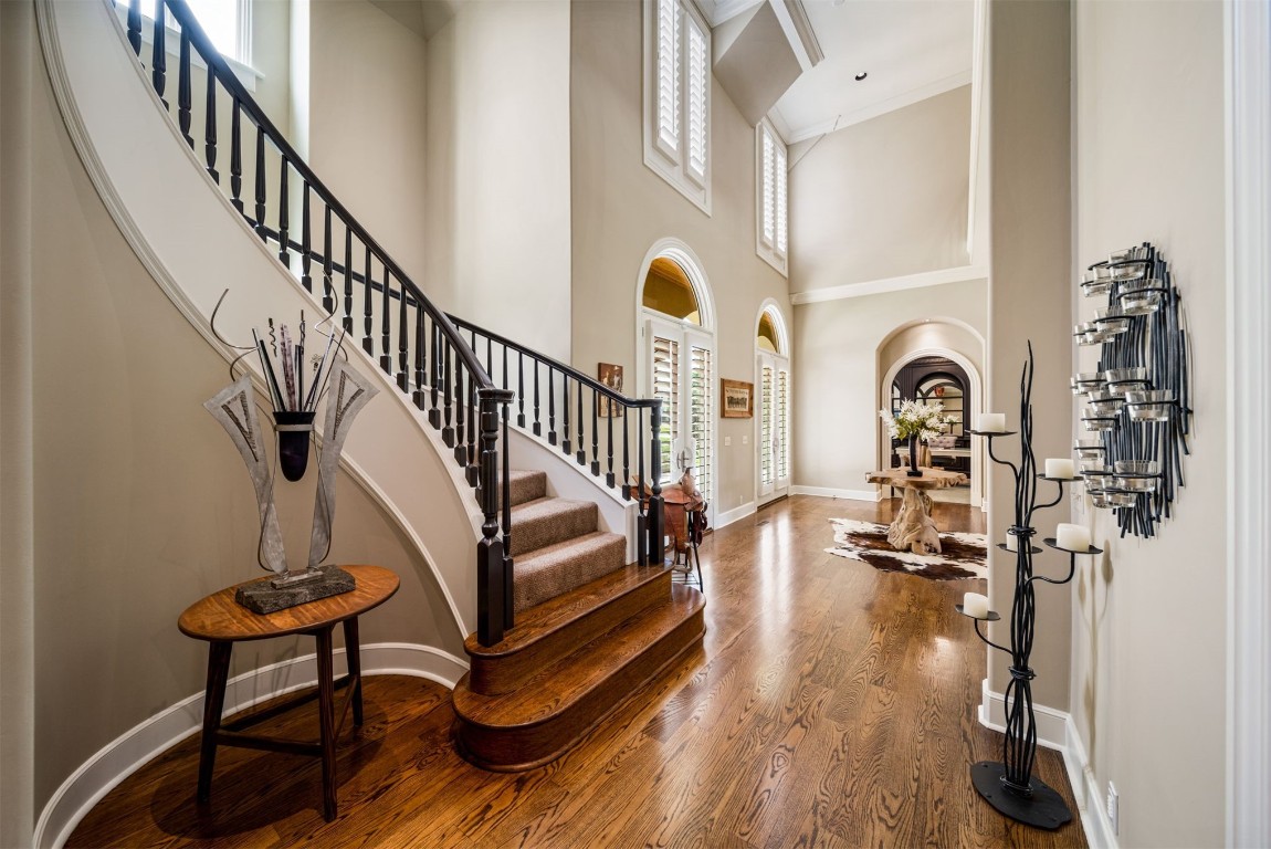 8726 S Gary Avenue, Tulsa, OK 74137 foyer featuring wood-type flooring, a towering ceiling, and ornamental molding