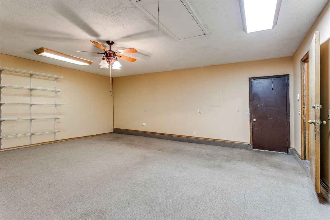 224 N Westminster Way, Mustang, OK 73064 empty room featuring a textured ceiling, carpet floors, and ceiling fan