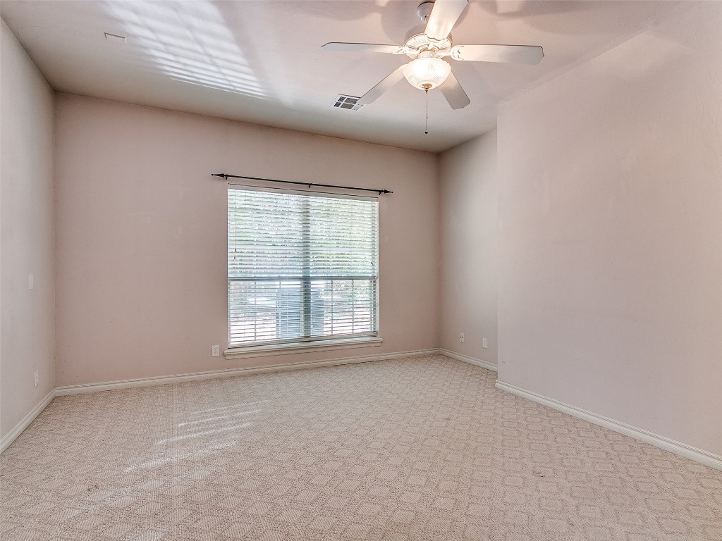 6508 NW 109th Place, Oklahoma City, OK 73162 spare room featuring ceiling fan and light carpet