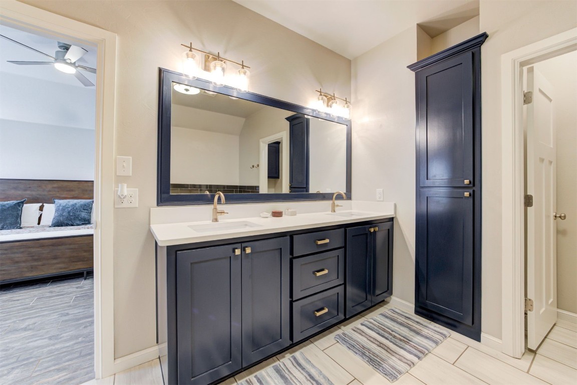 6233 Beverly Hills Drive, Edmond, OK 73034 bathroom with dual bowl vanity, tile floors, and ceiling fan