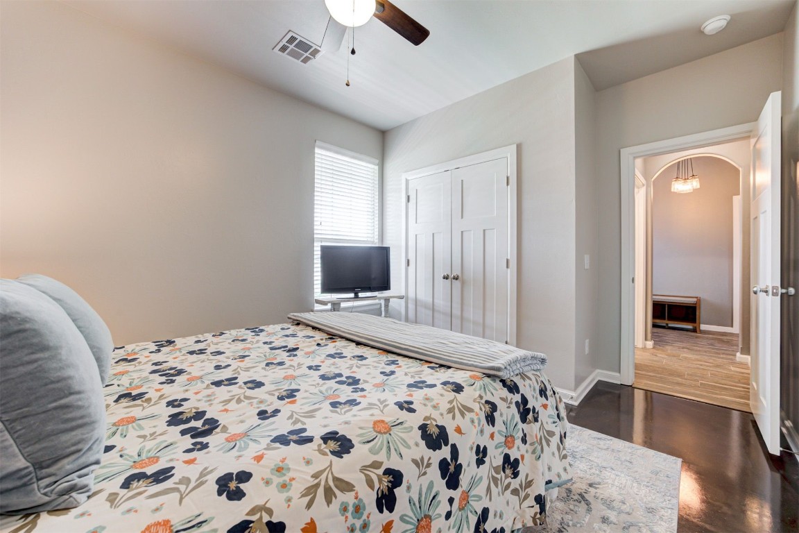 6233 Beverly Hills Drive, Edmond, OK 73034 bedroom featuring a closet, ceiling fan, and dark wood-type flooring