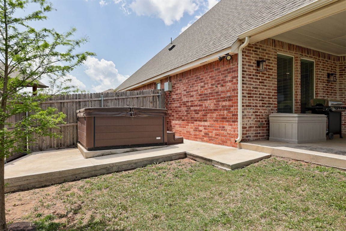 6233 Beverly Hills Drive, Edmond, OK 73034 view of yard featuring a hot tub and a patio area