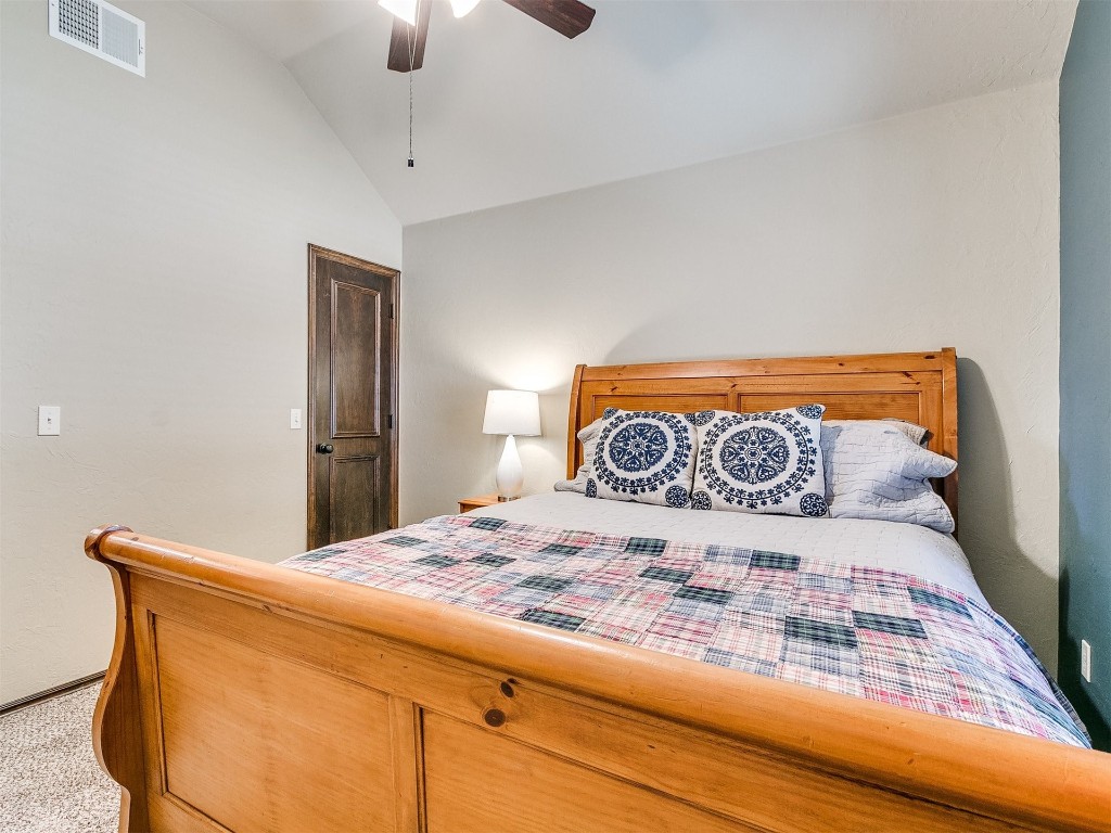 1900 Alexander Way, Yukon, OK 73099 carpeted bedroom with lofted ceiling and ceiling fan