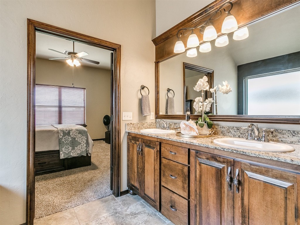 1900 Alexander Way, Yukon, OK 73099 bathroom featuring a wealth of natural light, dual bowl vanity, tile flooring, and ceiling fan