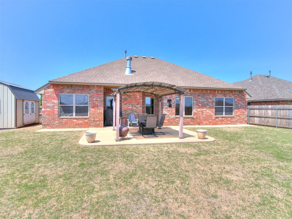 1900 Alexander Way, Yukon, OK 73099 rear view of house with a patio area, a yard, and a pergola