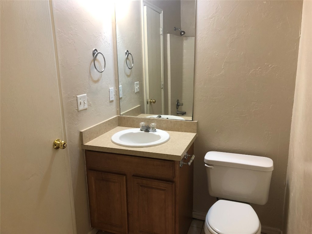 Address Hidden bathroom featuring oversized vanity and toilet