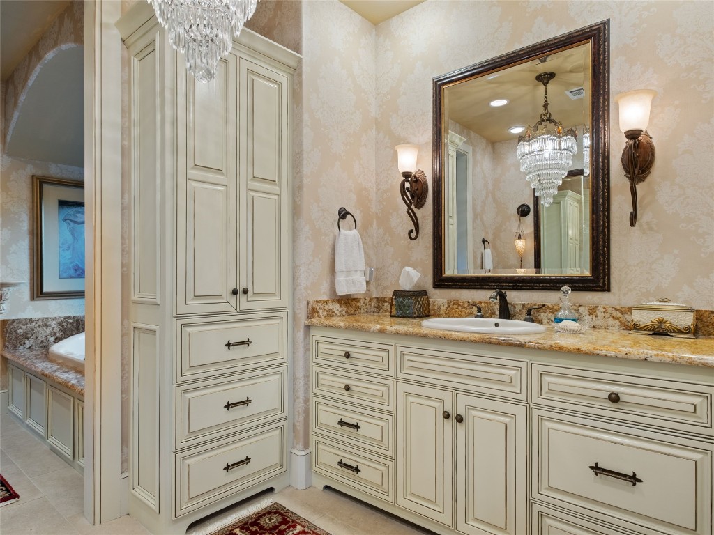 5300 Carrington Place, Oklahoma City, OK 73131 bathroom with vanity, tile floors, and an inviting chandelier