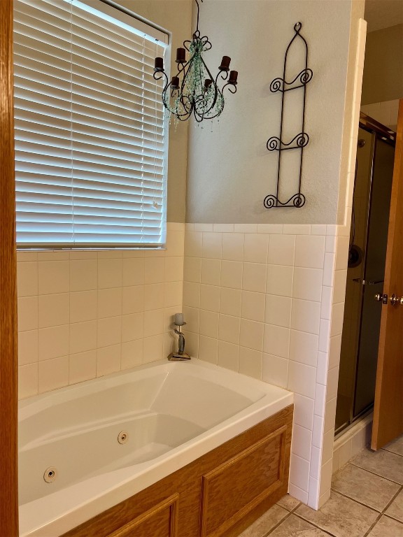 180 N Lakeside Terrace, Mustang, OK 73064 bathroom with a healthy amount of sunlight, plus walk in shower, tile floors, and an inviting chandelier