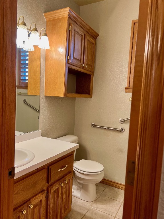 180 N Lakeside Terrace, Mustang, OK 73064 bathroom featuring tile flooring, toilet, and large vanity