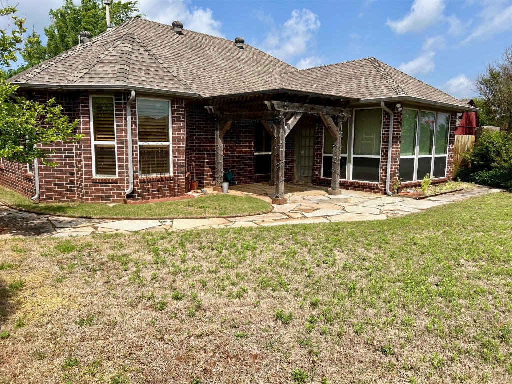 180 N Lakeside Terrace, Mustang, OK 73064 back of property with a patio and a yard