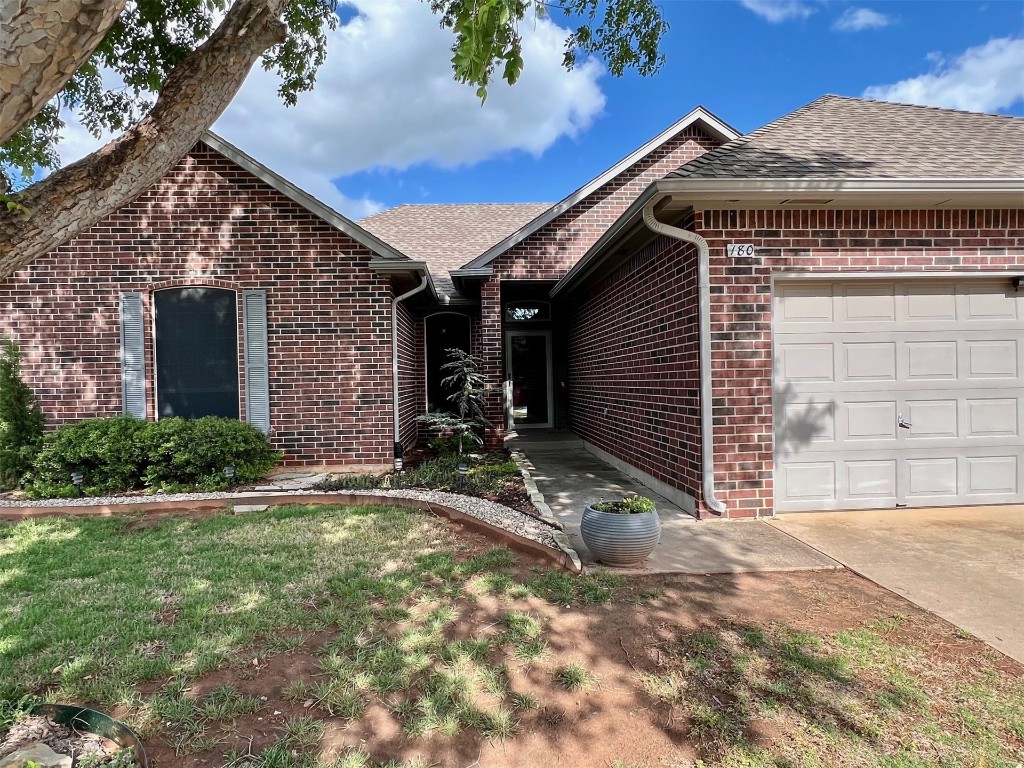 180 N Lakeside Terrace, Mustang, OK 73064 ranch-style home featuring a garage