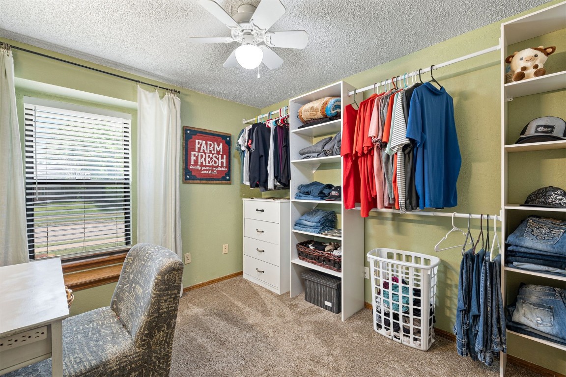 1816 SE 13th Street, Moore, OK 73160 spacious closet featuring ceiling fan and carpet