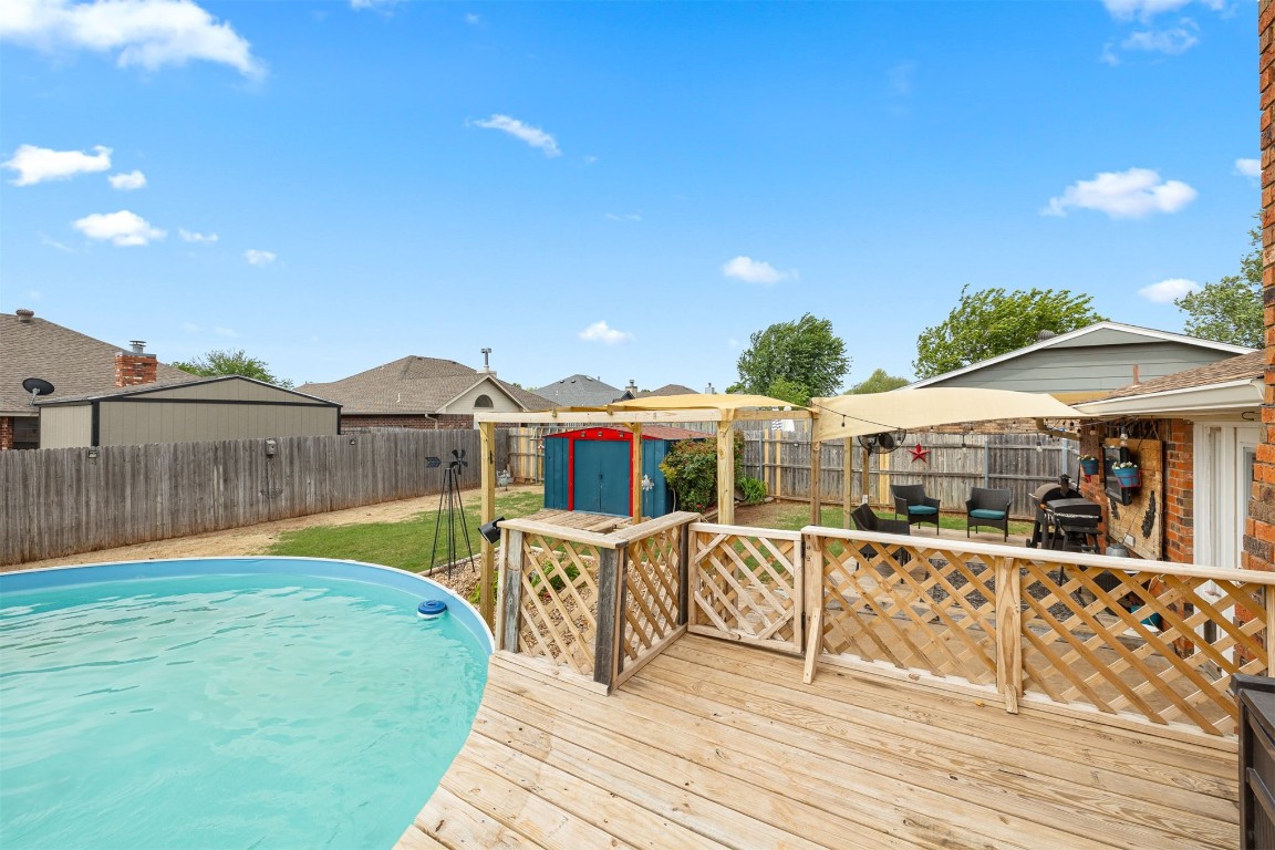 1816 SE 13th Street, Moore, OK 73160 wooden terrace featuring a storage unit