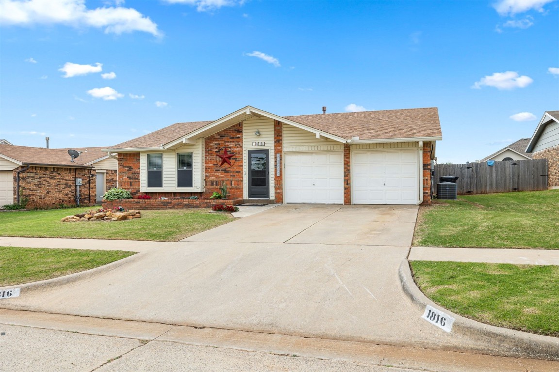 1816 SE 13th Street, Moore, OK 73160 ranch-style home featuring a garage, central AC unit, and a front yard
