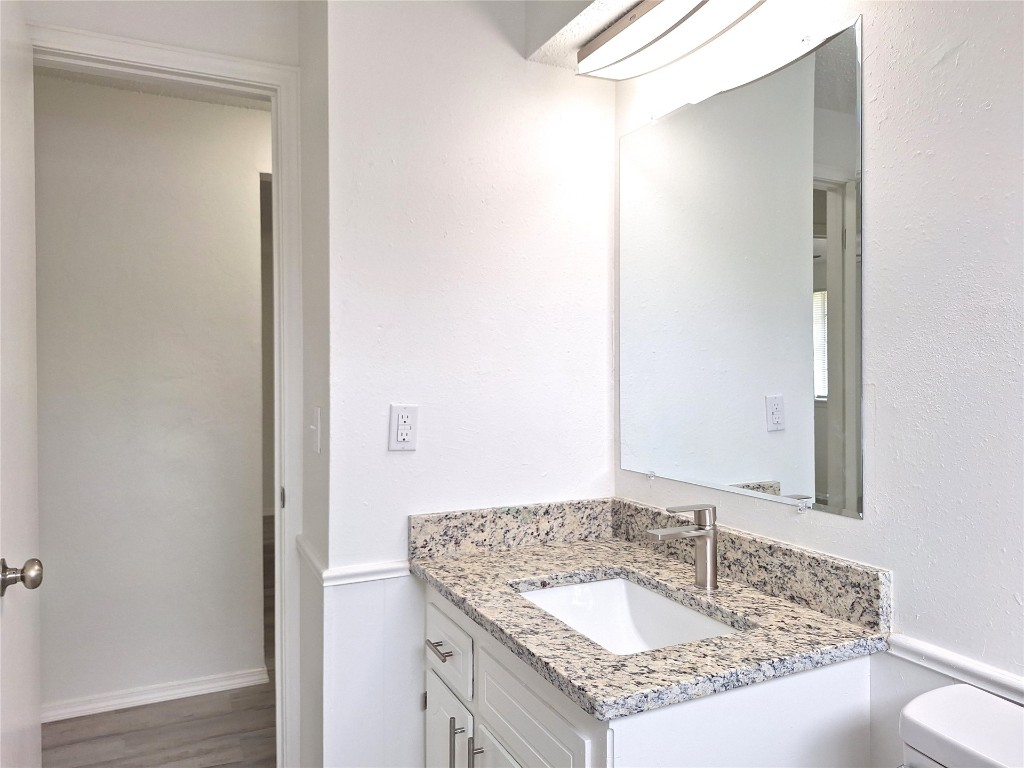 4116 SE 45th Terrace, Oklahoma City, OK 73135 bathroom with hardwood / wood-style flooring, vanity, and toilet