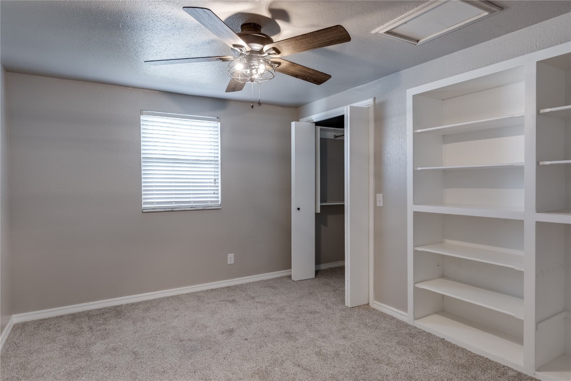 3620 Ridgehaven Drive, Midwest City, OK 73110 unfurnished bedroom with light carpet and ceiling fan
