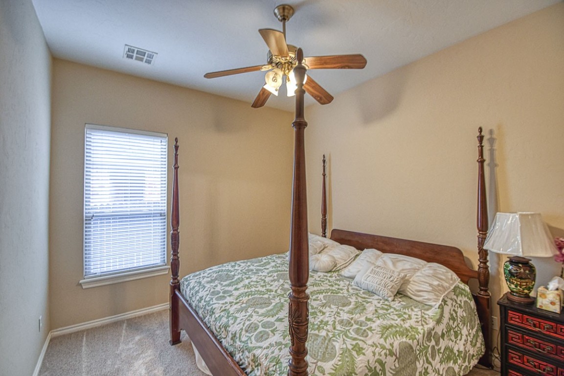 4508 Greystone Lane, Norman, OK 73072 carpeted bedroom with ceiling fan