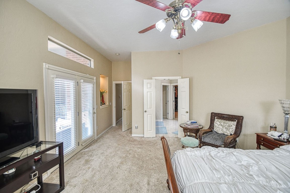 4508 Greystone Lane, Norman, OK 73072 carpeted bedroom with ceiling fan and access to outside