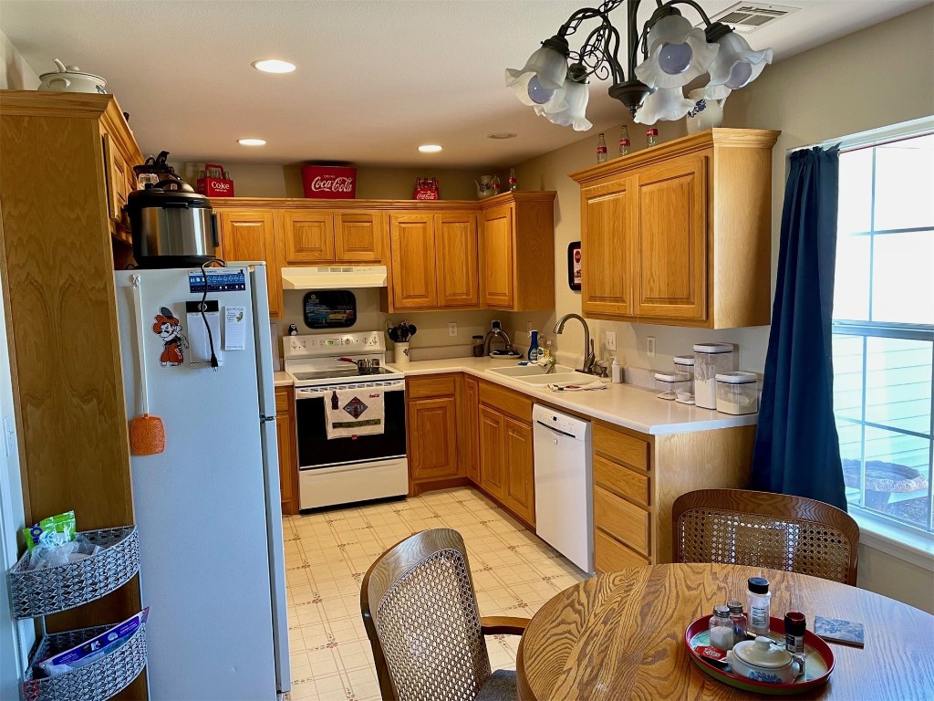 1523 N Grandview Street, Stillwater, OK 74075 kitchen with sink, white appliances, and light tile floors