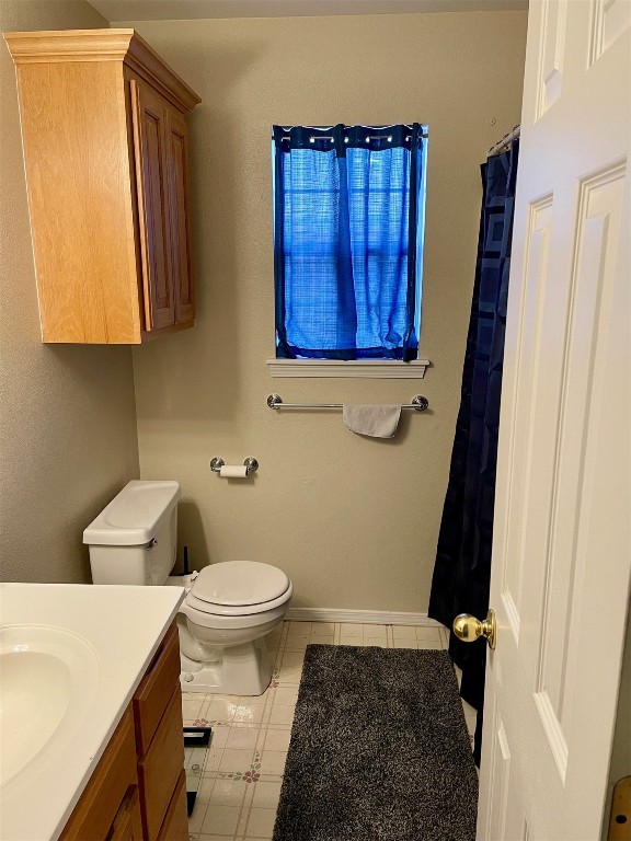 1523 N Grandview Street, Stillwater, OK 74075 bathroom with vanity, toilet, and tile flooring