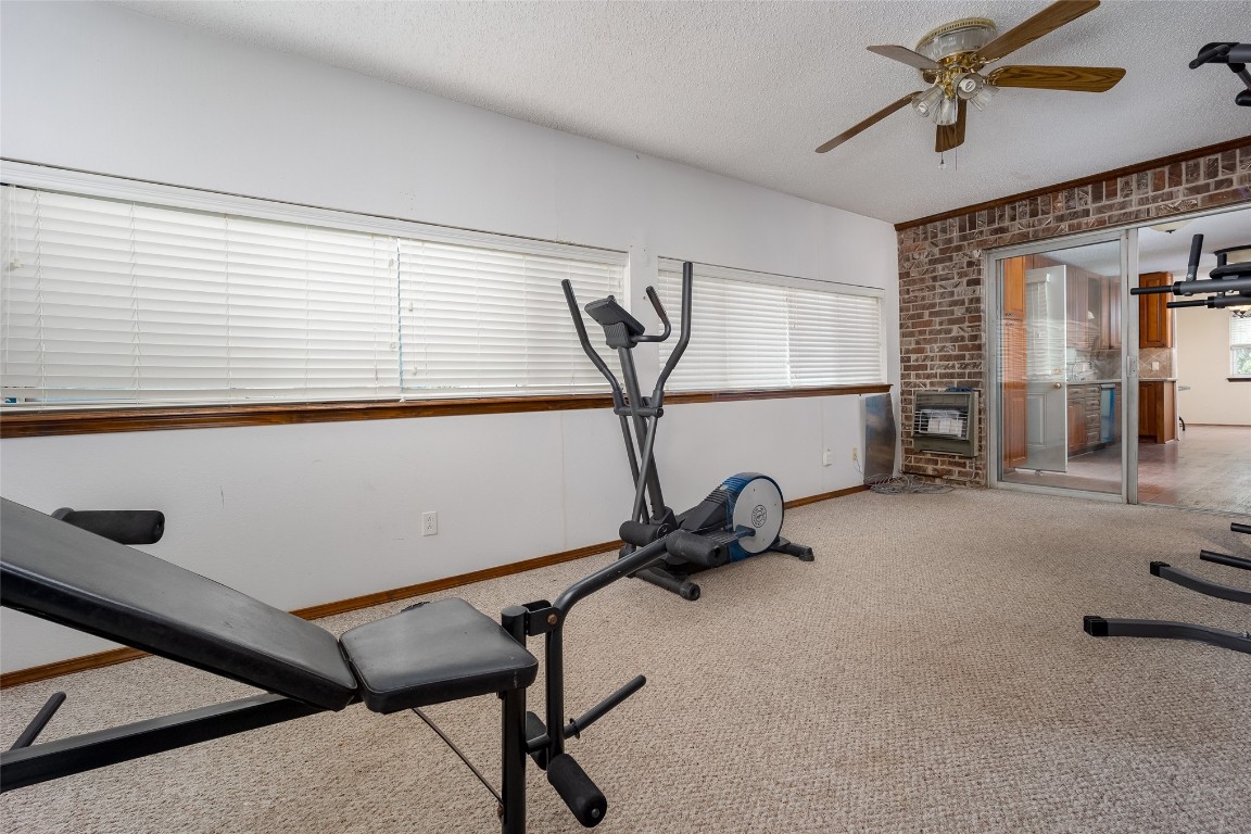 13494 290th Street, Blanchard, OK 73010 exercise room with a healthy amount of sunlight, ceiling fan, and carpet