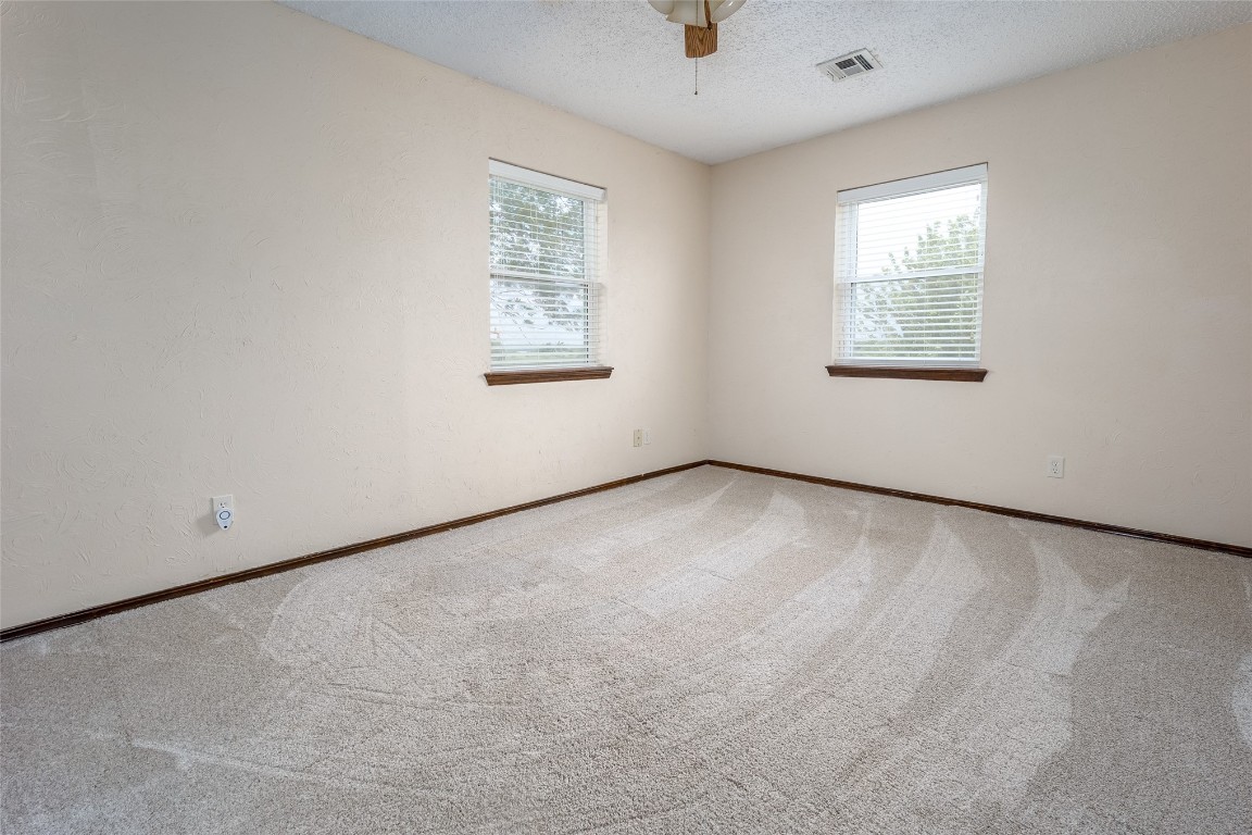 13494 290th Street, Blanchard, OK 73010 carpeted spare room featuring ceiling fan and a textured ceiling