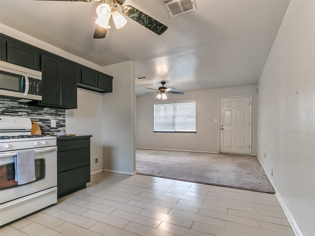 645 SW 3rd St, Moore, OK 73160 kitchen with backsplash, ceiling fan, light tile floors, and gas range gas stove