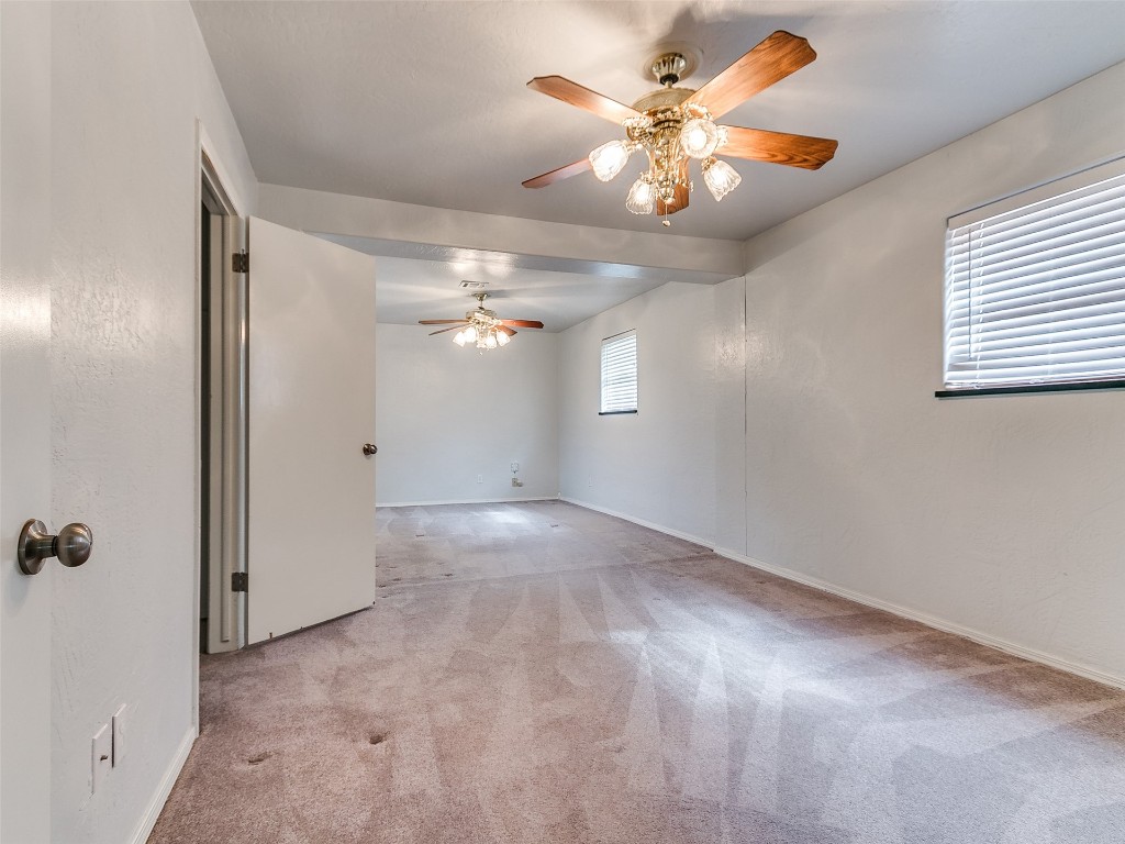 645 SW 3rd St, Moore, OK 73160 spare room with a wealth of natural light, ceiling fan, and carpet floors