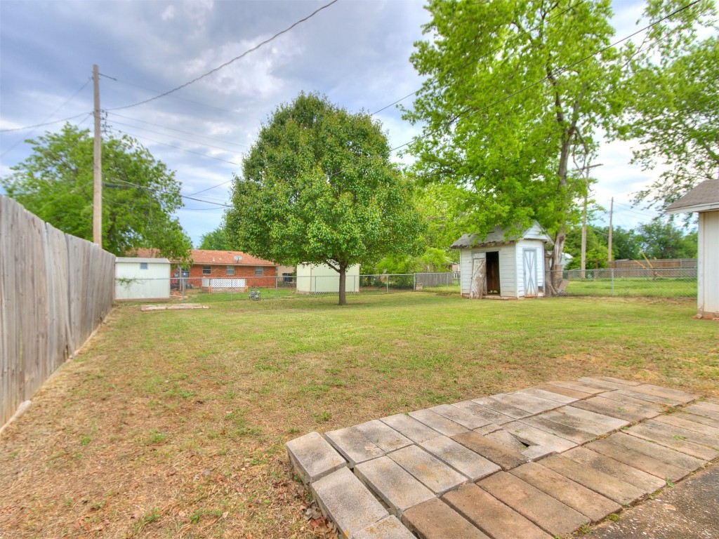 645 SW 3rd St, Moore, OK 73160 view of yard featuring a storage shed and a patio