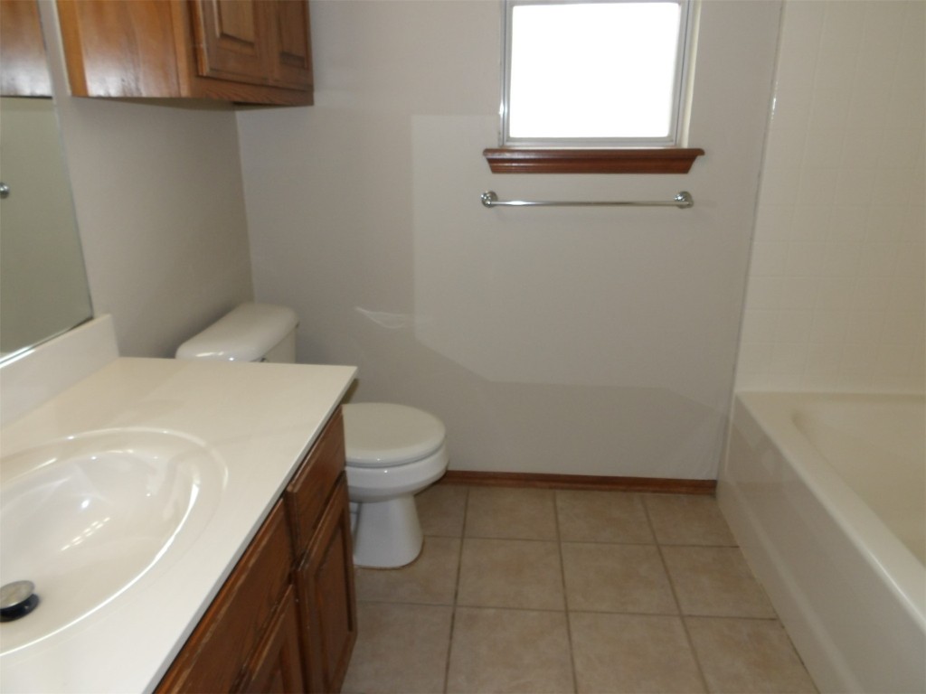 2424 Stonebridge Drive, Norman, OK 73071 full bathroom featuring dual bowl vanity, toilet, shower with separate bathtub, and tile flooring
