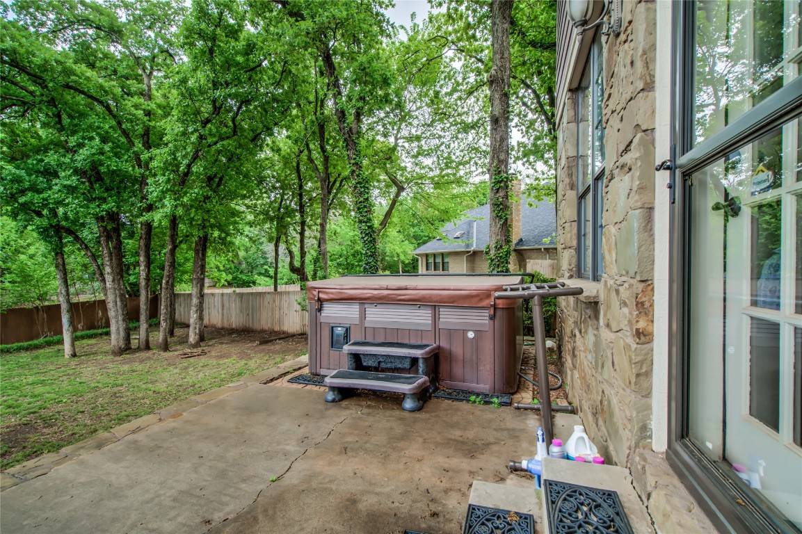 208 Crown Colony Court, Edmond, OK 73034 view of terrace with a hot tub