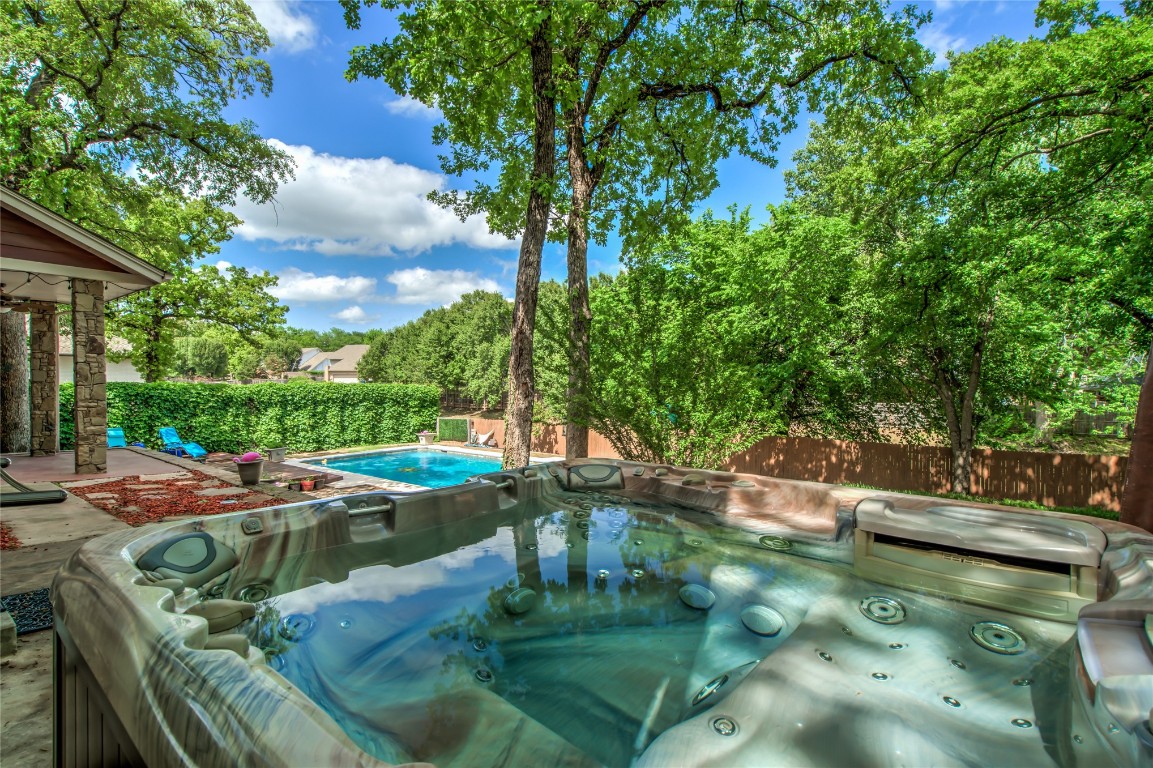 208 Crown Colony Court, Edmond, OK 73034 view of pool featuring a hot tub
