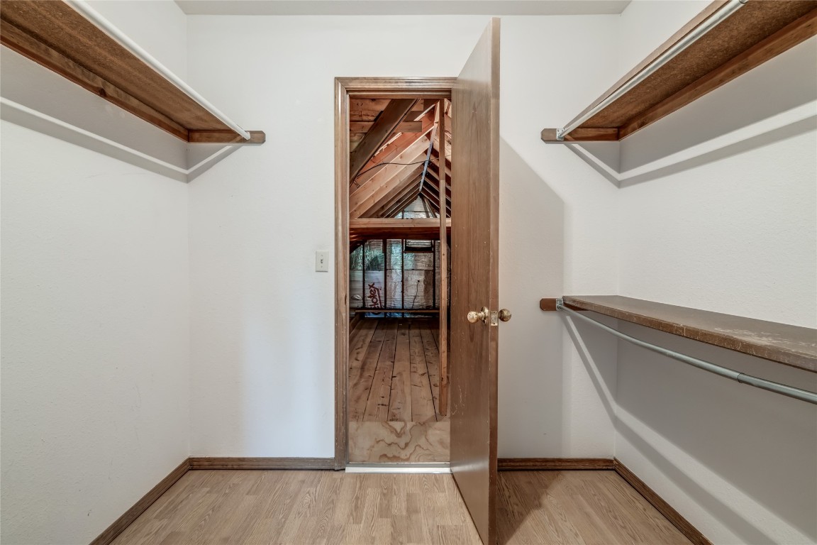 208 Crown Colony Court, Edmond, OK 73034 walk in closet featuring light hardwood / wood-style floors