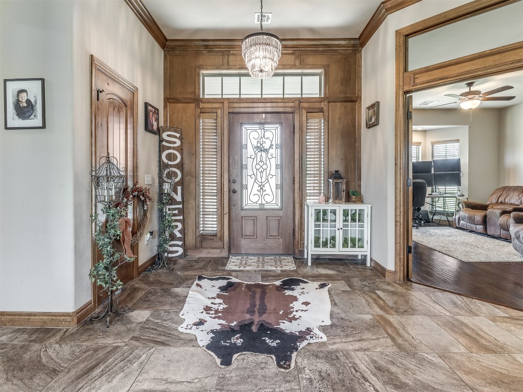 953 County Street 2982, Blanchard, OK 73010 entryway featuring ceiling fan with notable chandelier, plenty of natural light, crown molding, and tile floors