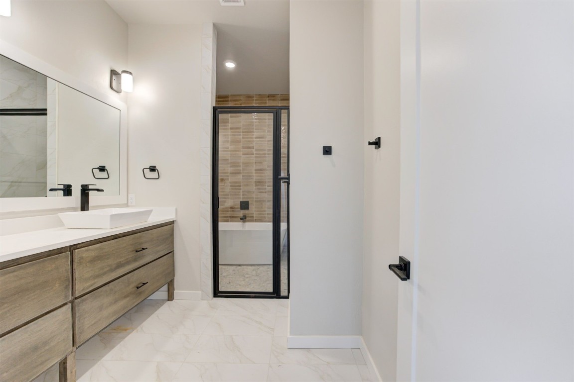 808 N Douglas Avenue, Oklahoma City, OK 73106 bathroom with walk in shower, large vanity, and tile flooring
