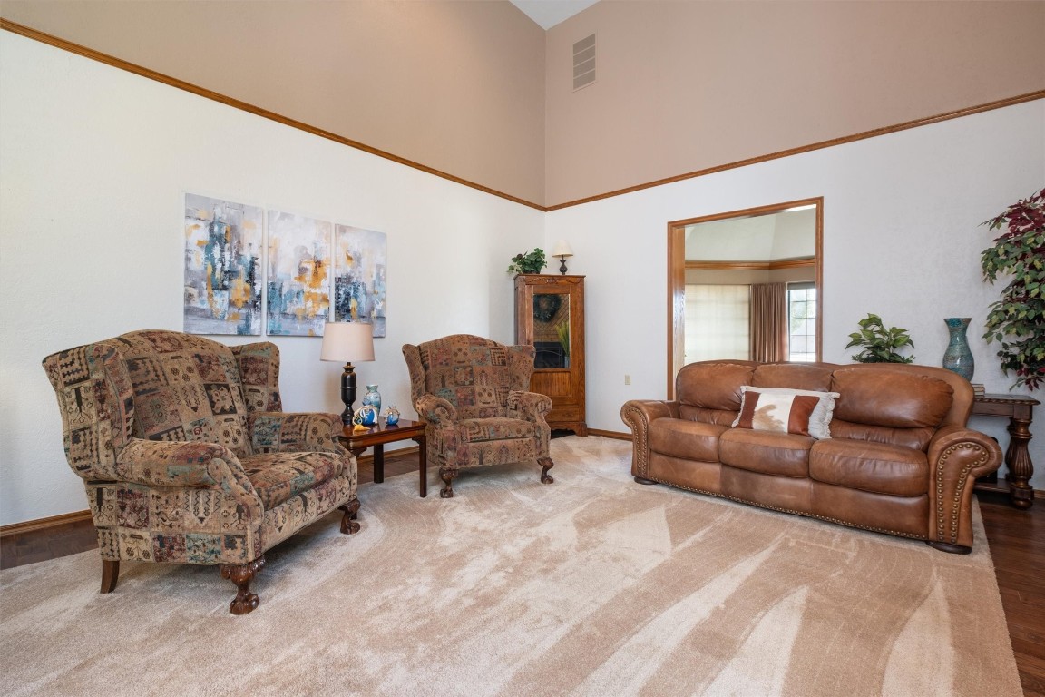 11517 Hackney Lane, Yukon, OK 73099 living room with hardwood / wood-style flooring and a towering ceiling