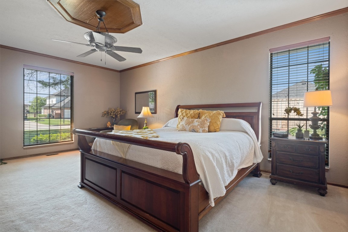 11517 Hackney Lane, Yukon, OK 73099 carpeted bedroom with ornamental molding and ceiling fan
