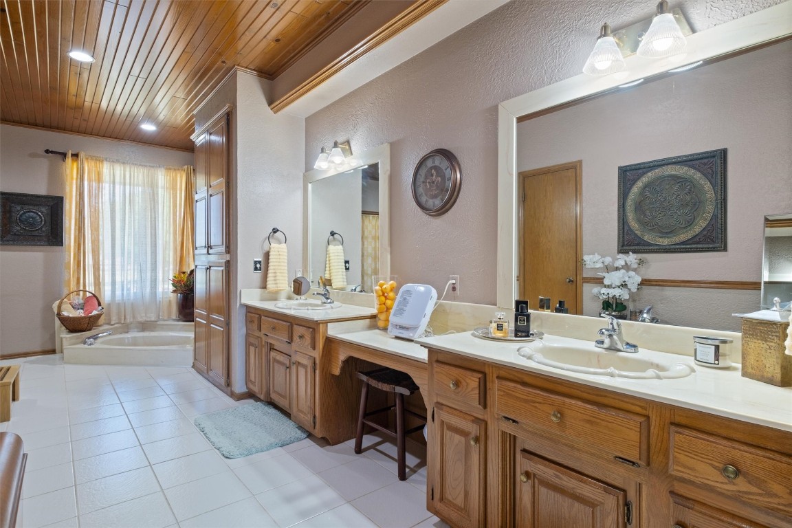 11517 Hackney Lane, Yukon, OK 73099 bathroom featuring wood ceiling, large vanity, a bath, and tile flooring