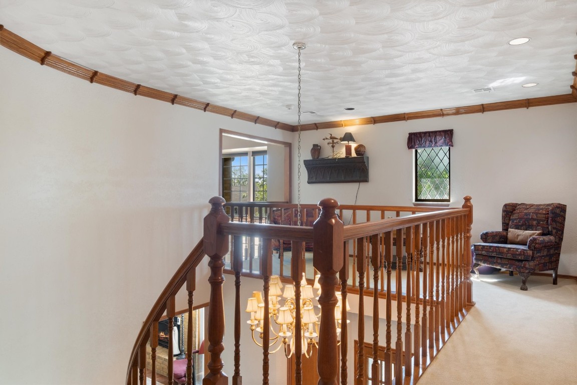 11517 Hackney Lane, Yukon, OK 73099 staircase with crown molding, a chandelier, and carpet floors