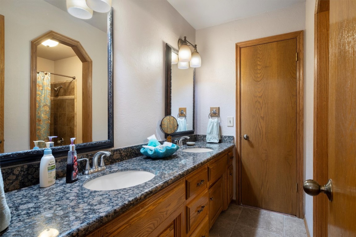 11517 Hackney Lane, Yukon, OK 73099 bathroom with tile flooring, dual sinks, and vanity with extensive cabinet space