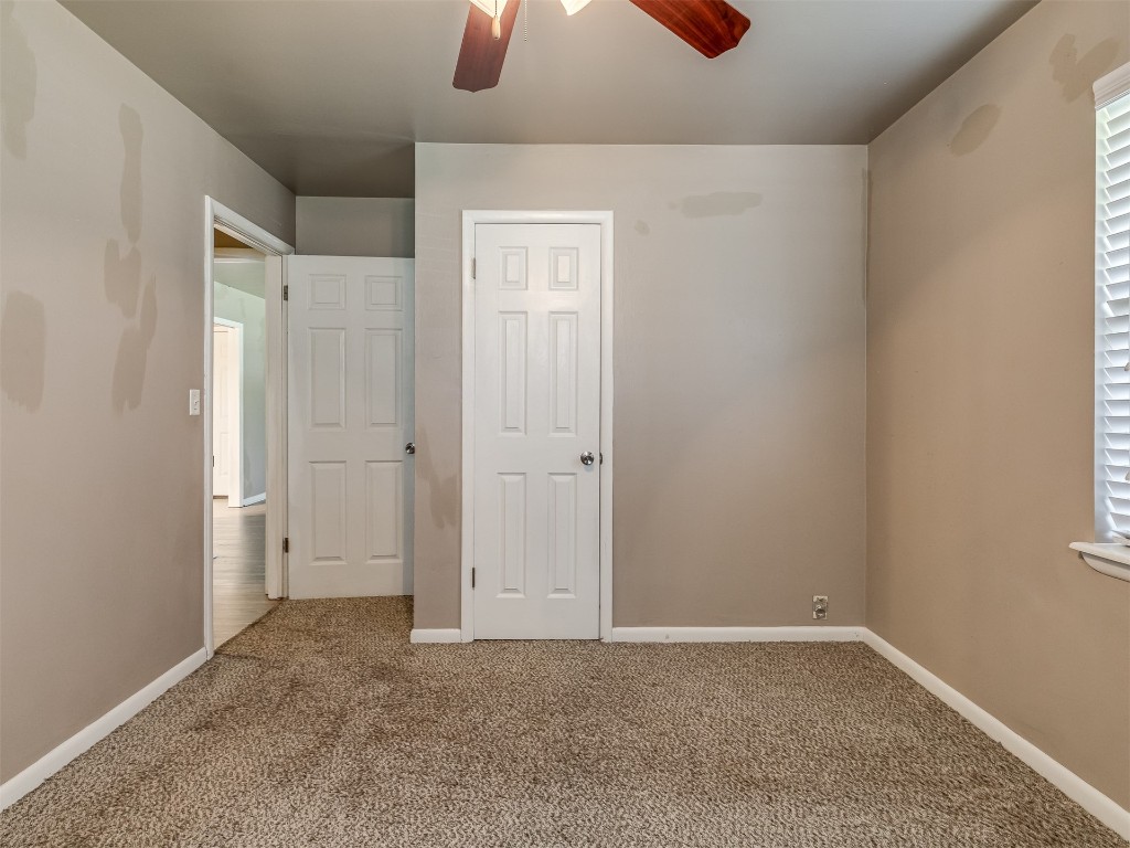 1706 Janeen Street, Yukon, OK 73099 unfurnished bedroom with ceiling fan and carpet floors
