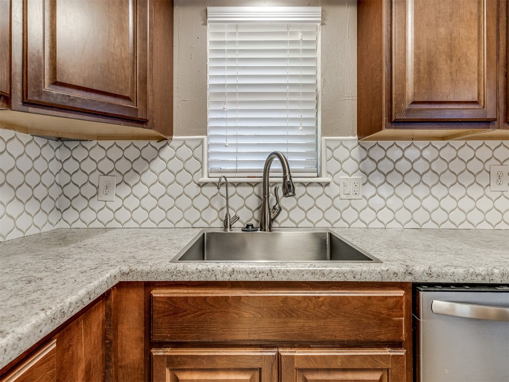 1706 Janeen Street, Yukon, OK 73099 kitchen with sink, tasteful backsplash, and stainless steel dishwasher
