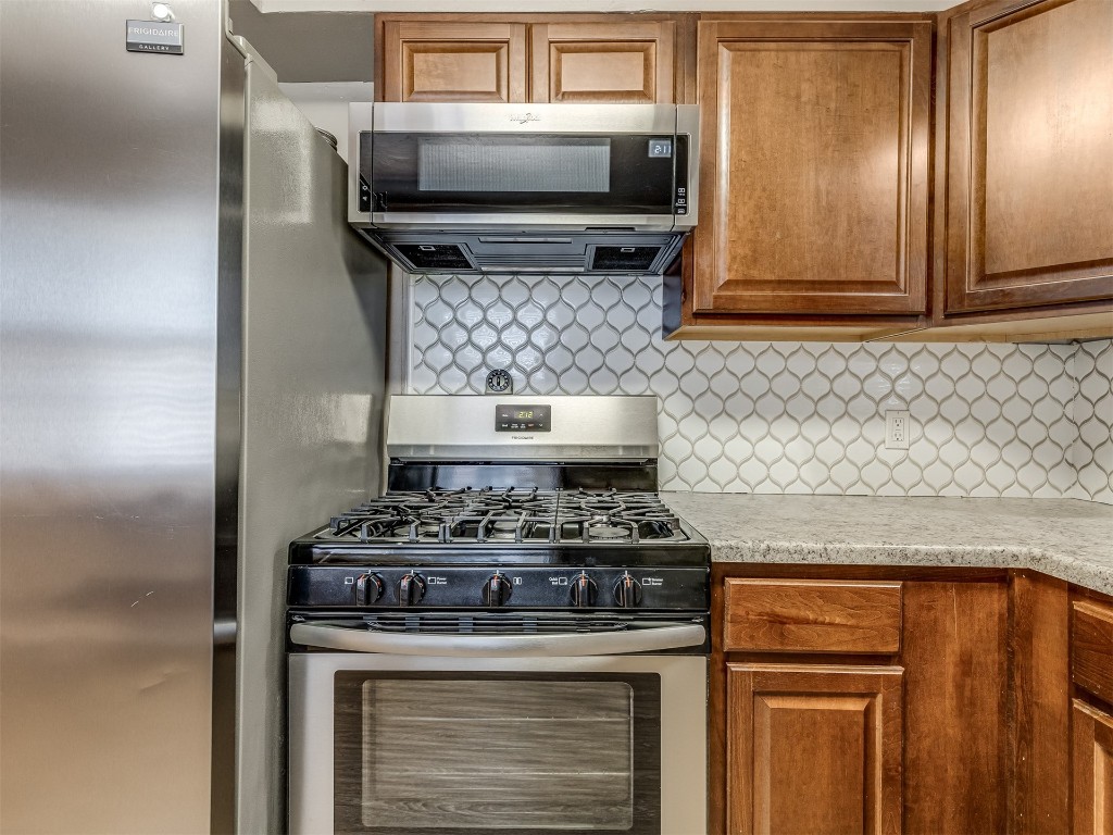 1706 Janeen Street, Yukon, OK 73099 kitchen featuring appliances with stainless steel finishes and tasteful backsplash