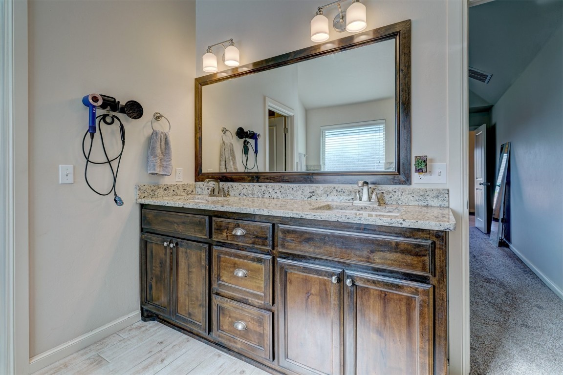 624 NW 188th Street, Edmond, OK 73012 bathroom with plenty of natural light, large vanity, and double sink