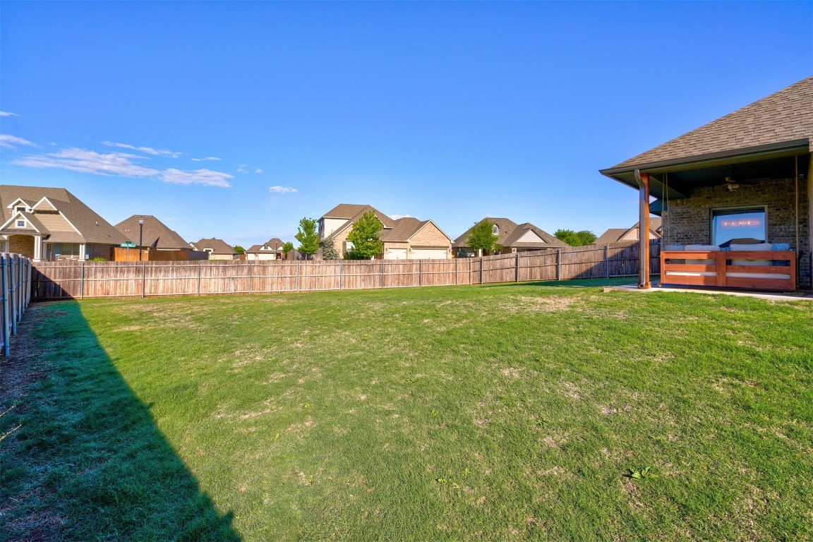 624 NW 188th Street, Edmond, OK 73012 back of property featuring a patio area and a yard