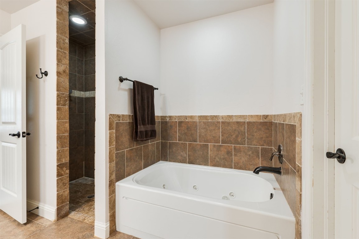 15409 Cardinal Nest Drive, Edmond, OK 73013 bathroom with tile floors and plus walk in shower