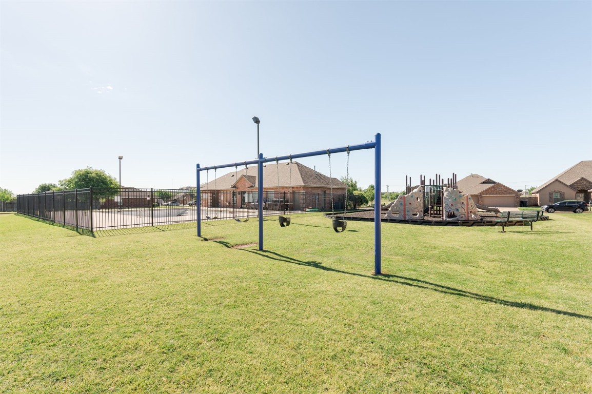 15409 Cardinal Nest Drive, Edmond, OK 73013 view of property's community with a playground and a yard
