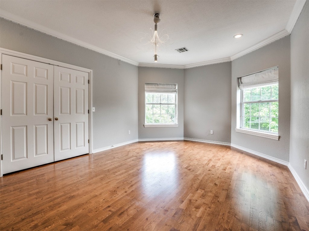 1307 Brookside Drive, Norman, OK 73072 unfurnished room with ornamental molding and hardwood / wood-style flooring